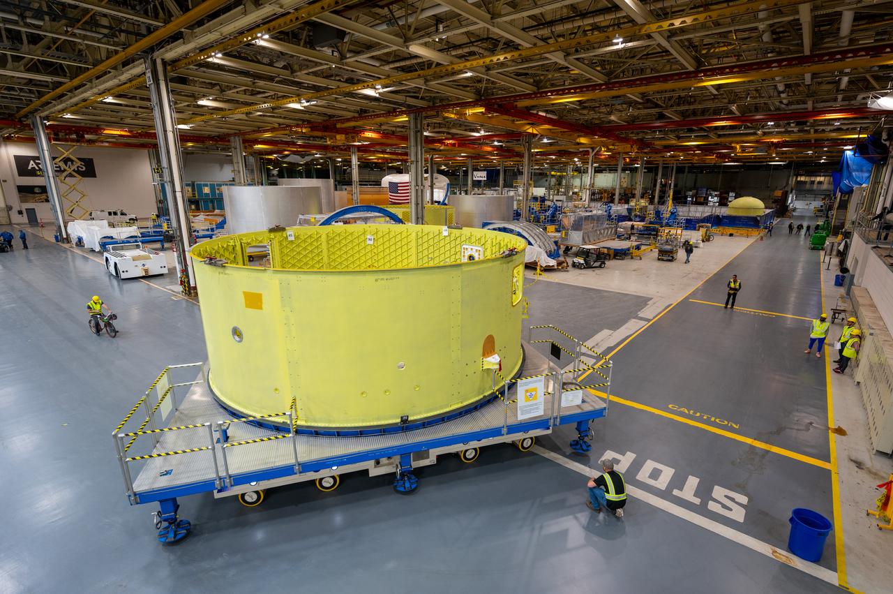 Crews at NASA’s Michoud Assembly Facility in New Orleans move the forward skirt of NASA’s Space Launch System (SLS) rocket to another part of the facility Dec. 15. Teams are preparing to apply the thermal protection system to the flight hardware, which will protect it from the extreme temperatures during launch and flight. The forward skirt is part of the core stage that will power the SLS rocket for the Artemis III mission. The forward skirt houses flight computers, cameras, and avionics.. The SLS core stage is made up of five unique elements: the forward skirt, liquid oxygen tank, intertank, liquid hydrogen tank, and the engine section. When fully stacked, the forward skirt is located at the top of the core stage and connects the stage to the upper part of the rocket. Together with its four RS-25 engines, the rocket’s massive 212-foot-tall core stage — the largest stage NASA has ever built — and its twin solid rocket boosters produce 8.8 million pounds of thrust to send NASA’s Orion spacecraft, astronauts and supplies beyond Earth’s orbit to the Moon and, ultimately, Mars. Offering more payload mass, volume capability and energy to speed missions through space, the SLS rocket, along with NASA’s Gateway in lunar orbit, the Human Landing System, and Orion spacecraft, is part of NASA’s backbone for deep space exploration and the Artemis lunar program. No other rocket is capable of carrying astronauts in Orion around the Moon in a single mission.